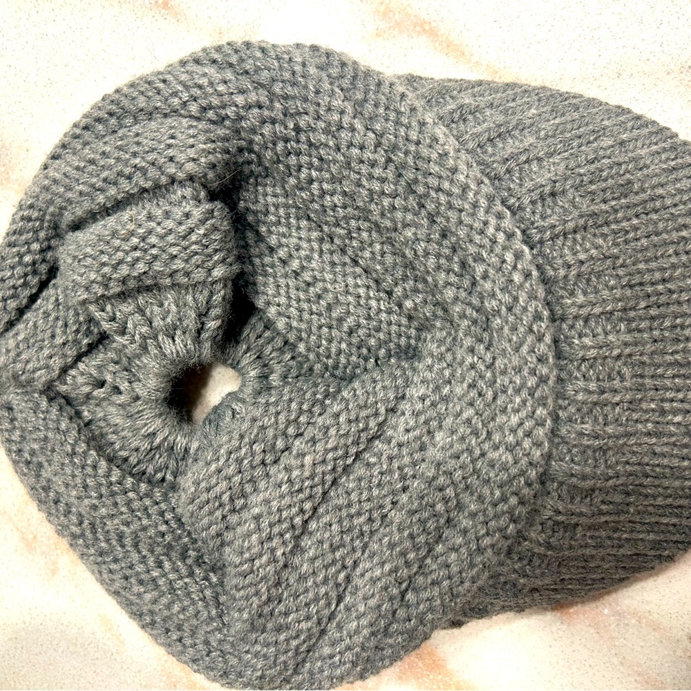 Super cute light gray knit cap with brim and ponytail opening.